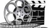 Filmrolle und Filmband, dahinter Filmklappe