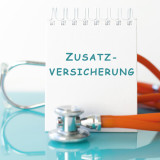 Block mit "Zusatzversicherung" und Stetoskop