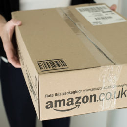 Frau hält Amazon-Paket in den Händen