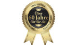 Goldenes Siegel mit der Aufschrift "Über 60 Jahre für Sie da!"