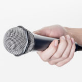 Mikrofon wird von einer Frauen-Hand gehalten