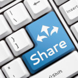 Share Button auf einer Tastatur symbolisiert Filesharing