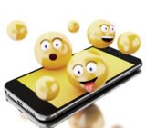 verschiedene gelbe 3D-Emojis und gelbe Kugeln über einem Smartphone