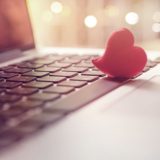 Online-Partnervermittlung - rotes Herz auf Laptop