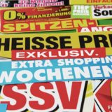 viele bunte Plakate, die Rabattaktionen ankündigen