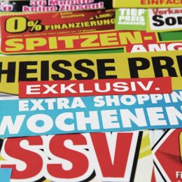 viele bunte Plakate, die Rabattaktionen ankündigen