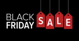 Black Friday SALE, rote Preisschilder vor schwarzem Hintergrund