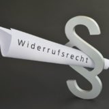 Fotolia_107190236: Gerolltes Blatt mit der Aufschrift Widerrufsrecht in einem Paragaphen.