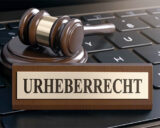 Ein Richterhammer und ein Schild Urheberrecht liegen auf einer Tastatur