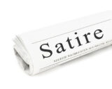 Zeitung mit Aufschrift Satire